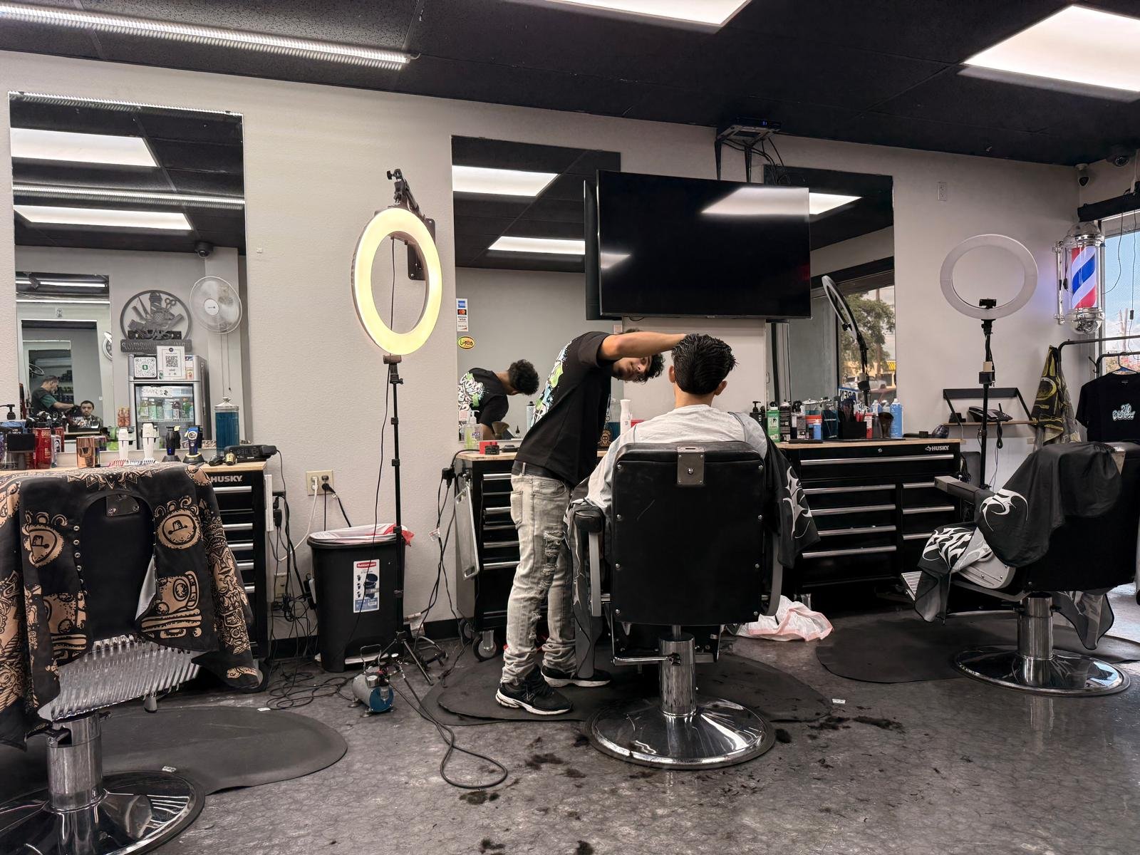 Prince BarberShop interior with barber serving client in San Antonio